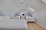 Second floor bedroom featuring a queen size and two twin size beds